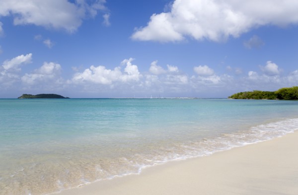 WEST INDIES, Grenada, Carriacou, The calm clear blue water breaking on Paradise Beach in L'Esterre
