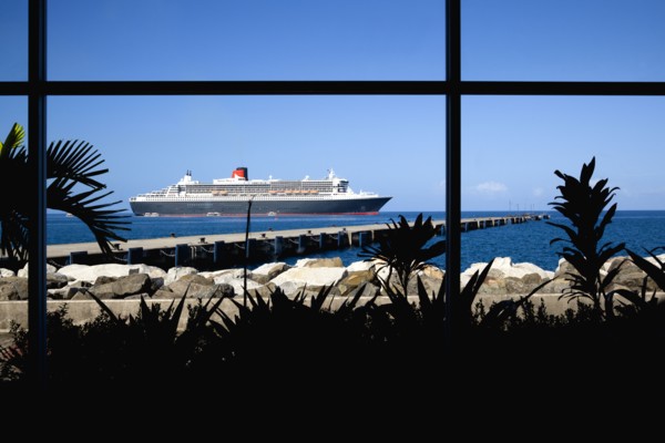 WEST INDIES, Grenada, St George, The Queen Mary 2 liner at anchor beyond a jetty off the capital