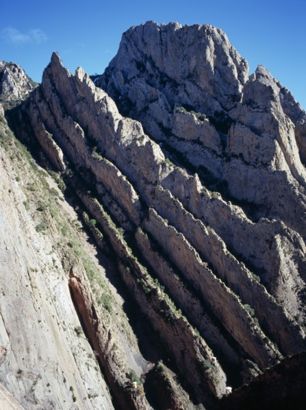 SPAIN, Catalonia, Lleida, Near vertical strata of crumbling limestone rock along Rio Noguera