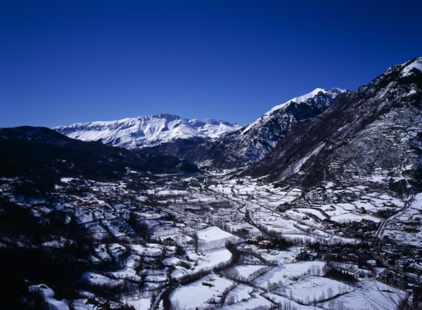 SPAIN, Aragon, Pyrenees, Elevated view south west along Rio Esera with snow covered valley and