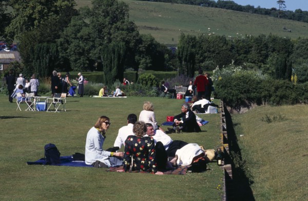 ENGLAND, East Sussex, Glyndebourne, Opera attendees enjoying picnics in the gardens during interval