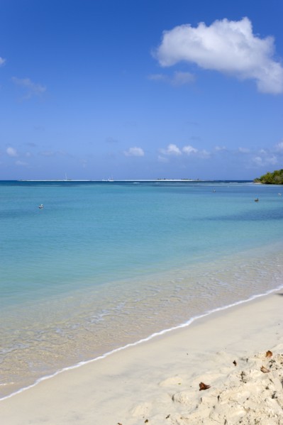 WEST INDIES, Grenada, Carriacou, Waves breaking on Paradise Beach at L'Esterre Bay with the