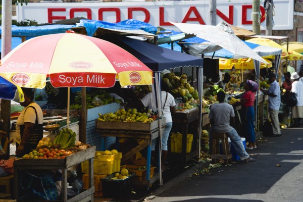 WEST INDIES, Grenada, St Georges, Busy fruit and vegetable stalls under umbrellas in Market Square