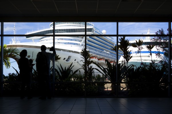 WEST INDIES, Grenada, St George, Tourists in the terminal building looking at the cruise ship