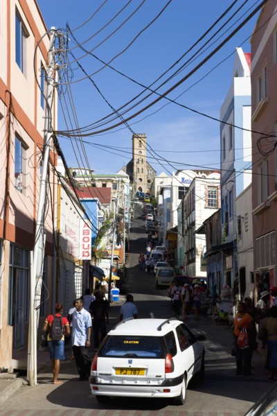 WEST INDIES, Grenada, St George, St Juille Street with overhead power cables busy with traffic and
