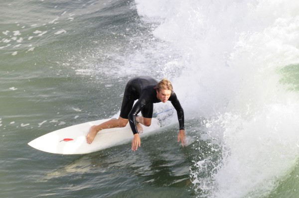 USA, California, Los Angeles, Surfer riding waves at Manhattan Beach