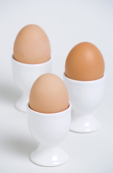 FOOD, Uncooked, Eggs, Three boiled free range eggs in egg cups.