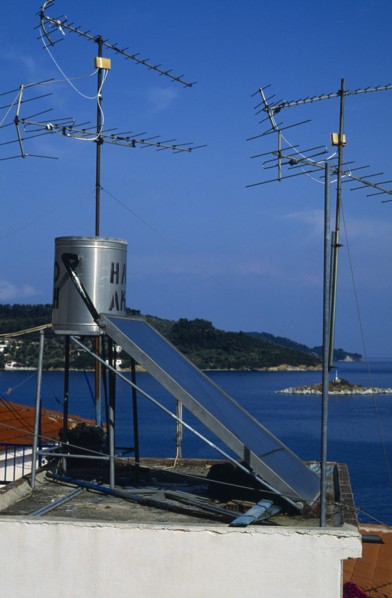 Environment, Energy, Solar Power, Solar power panel amongst aerials on the roof of a house in