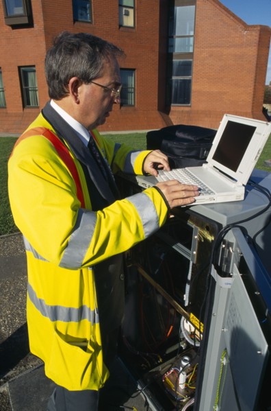 England, West Sussex, Shoreham-by-sea, IT Technician programming traffic lights signal box from a