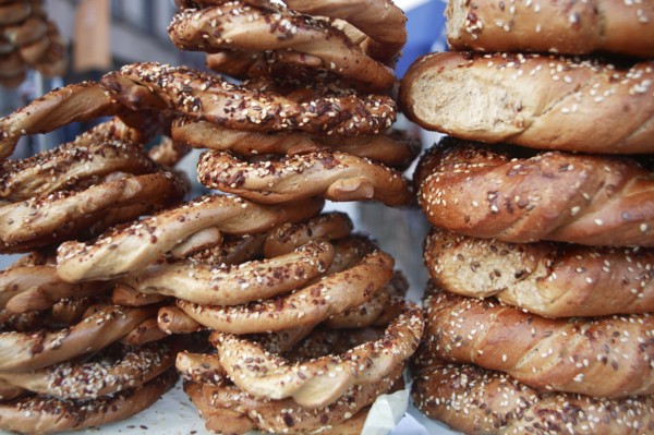 Poland, Krakow, Obwarzaneck,twisted rings of bread strewn with poppy sale for sale from street