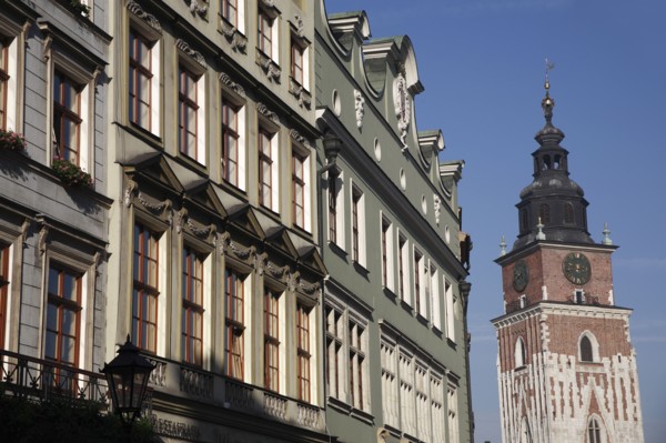 Poland, Krakow, Old Town Hall & pastel coloured buildings in the Rynek Glowny market square.