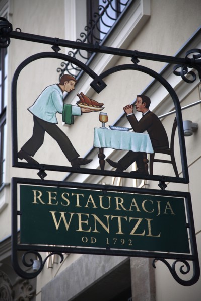 Poland, Krakow, sign for Restaurant Wentzl in the old city.