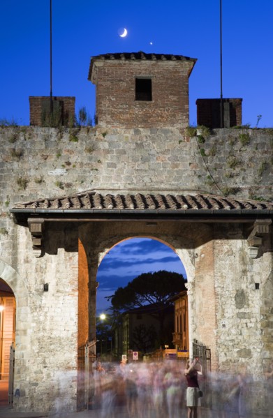 ITALY, Tuscany, Pisa, The Campo dei Miracoli or Field of Miracles.The west entrance gate at dusk