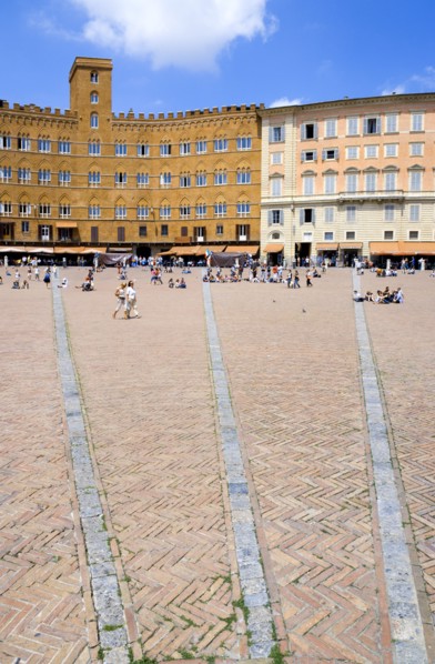 ITALY, Tuscany, Siena, The Piazza del Campo and surrounding buildings with tourists walking in the