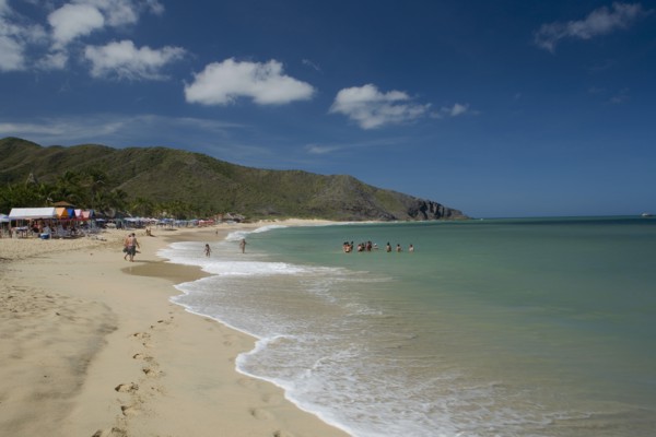 VENEZUELA, Margarita Island, Playa Caribe, View of exotic beach with people swimming and walking on