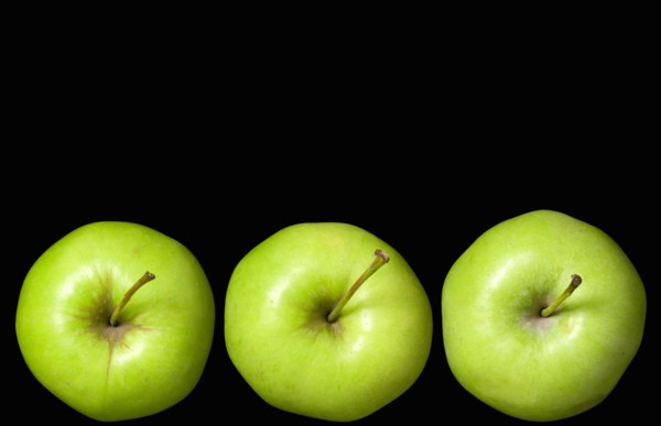 Food, Fruit, Apples, Three ripe green apples in a line seein from above showing the storks or stems