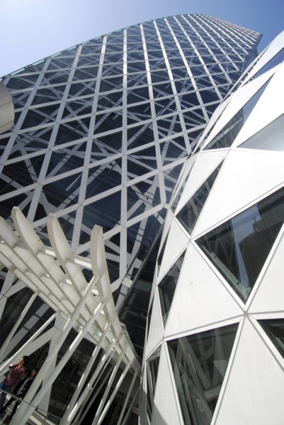Japan, Tokyo, Shinjuku, New Cocoon Building, unusual shape and design, young couple coming out of