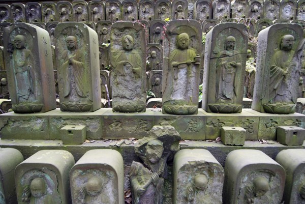 Japan, Tokyo, Nippori, Jyomo-in shrine, dozens of stone Jizo statues of the Buddha.