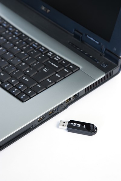 Industry, Computers, Components, 8 gigabyte portable USB flash drive storage device beside laptop