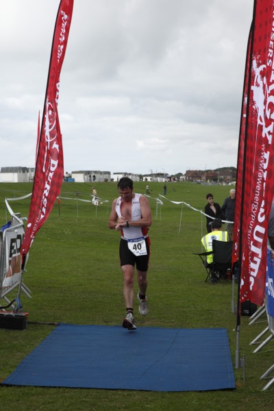 England, West Sussex, Goring-by-Sea, Worthing Triathlon 2009, male competitor checking his watch at