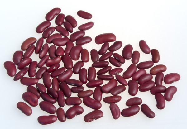 Food, Uncooked, Beans, Red kidney beans scattered on a white surface.