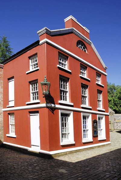 Omagh, County Tyrone, Ireland. Ulster American Folk Park red coloured house in the reconstructed