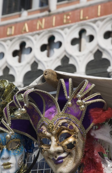 Venice, Veneto, Italy. Carnival masks in front of partly seen facade of Hotel Danieli. Italy Italia