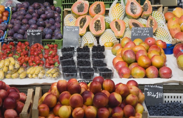 Vienna, Austria. Display of fresh fruit for sale on market stall including plums strawberries