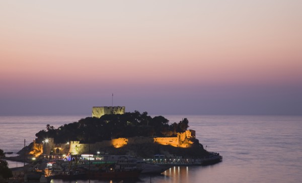 Kusadasi, Aydin Province, Turkey. Sunset over Guvercin Ada the peninsula of Kusadasi also known as