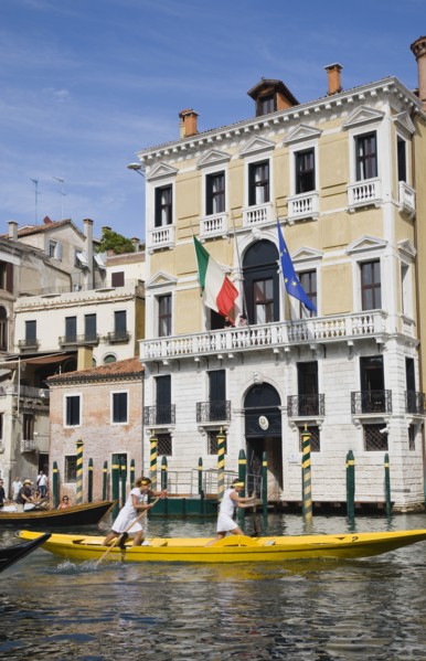 Venice, Veneto, Italy. Female pair taking part in Regata Storica Venice Regatta rowing yellow