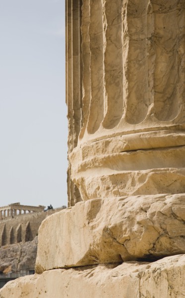 Athens, Attica, Greece. Base of ruined column on The Temple of Olympian Zeus with Parthenon and
