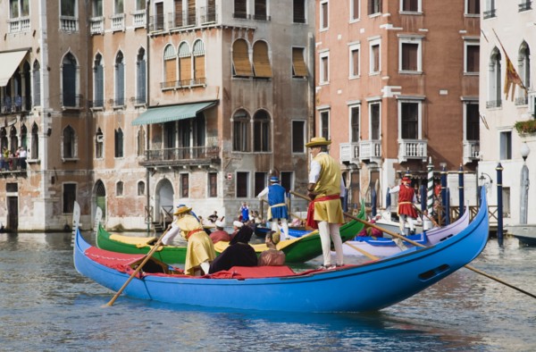 Venice, Veneto, Italy. Participants in the Regata Storico annual historical regatta in brightly