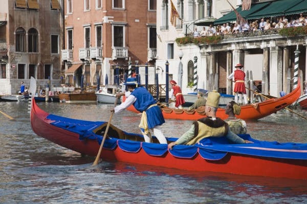 Venice, Veneto, Italy. Participants in the Regata Storico historical Regatta in brightly painted