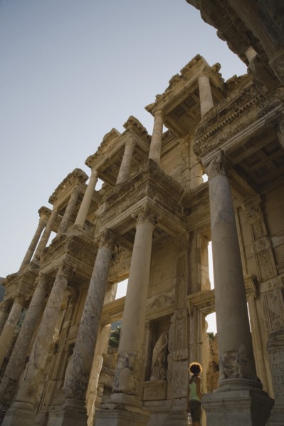 Selcuk, Izmir Province, Turkey. Ephesus. Roman Library of Celsus facade with young woman standing