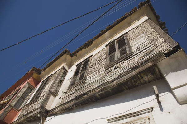Kusadasi, Aydin Province, Turkey. Angled part view of exterior facade of Ottoman era whitewashed