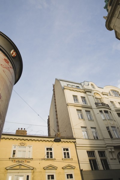 Vienna, Austria. Building exterior facades with partly seen advertising column in foreground.