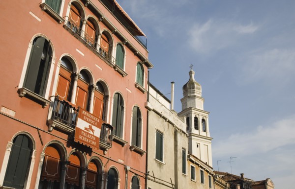 Venice, Veneto, Italy. Centro Storico Restored facade of building painted a terracotta colour with