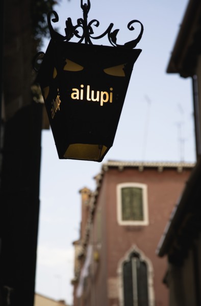 Venice, Veneto, Italy. Centro Storico Lantern outside restaurant inscribed with ai lupi which