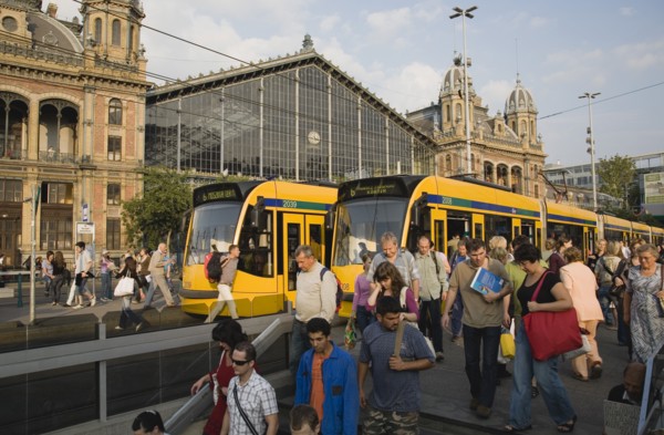 Budapest, Pest County, Hungary. Trams and crowd of passengers in front of rail terminus Budapest