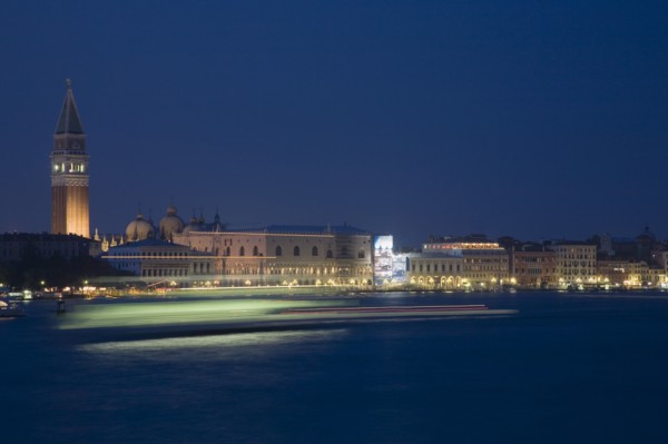 Venice, Veneto, Italy. Giudecca island Early evening view towards illuminated Campanile of St. Mark