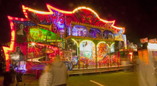 Lancing, West Sussex, England. Entertainment Funfairs Rides illuminated at night. England English