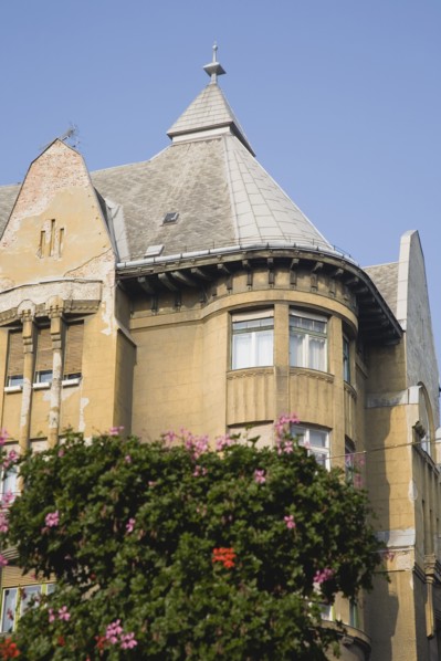 Budapest, Pest County, Hungary. Part view of Empire era apartment blocks with baskets of pink