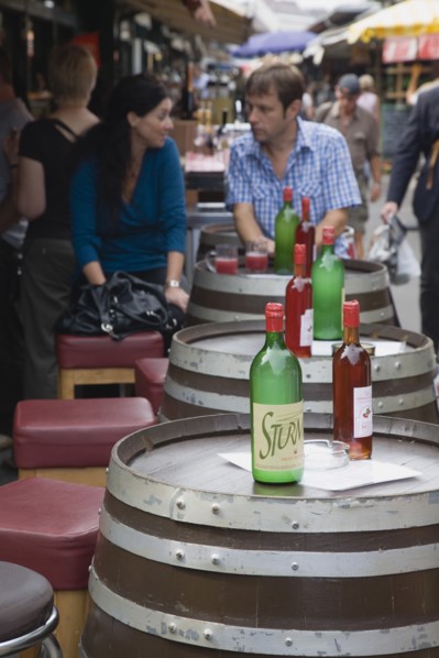 Vienna, Austria. Young couple having glass of Federweisser wine in the fermentation stage known as