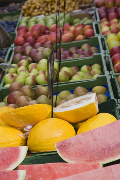 Vienna, Austria. The Naschmarkt. Market fruit stall with display of melon and apples. Austria