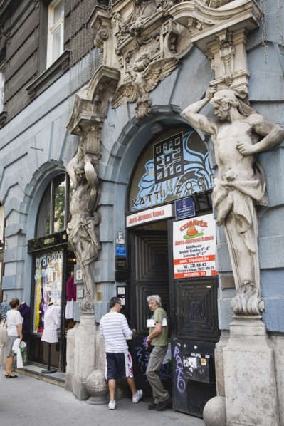 Budapest, Pest County, Hungary. Art Nouveau sculpture on facade of apartment building with local