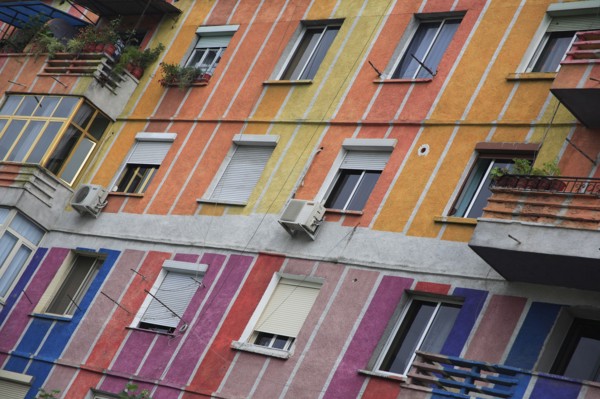Albania, Tirane, Tirana, Angled part view of exterior facade of apartment block painted in brightly