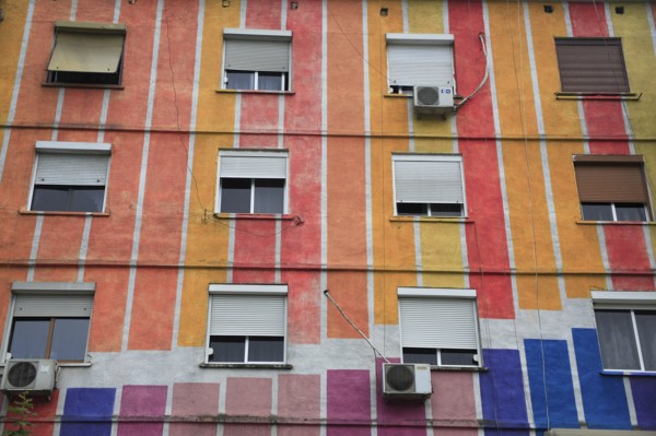 Albania, Tirane, Tirana, Part view of exterior facade of apartment block painted in stripes of