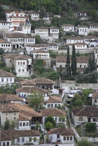 Albania, Berat, Traditional white painted Ottoman buildings with tiled rooftops on hillside in the