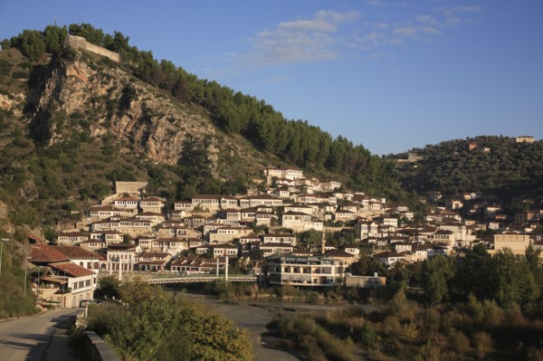 Albania, Berat, Traditional Ottoman buildings on hillside above footbridge over the River Osum.