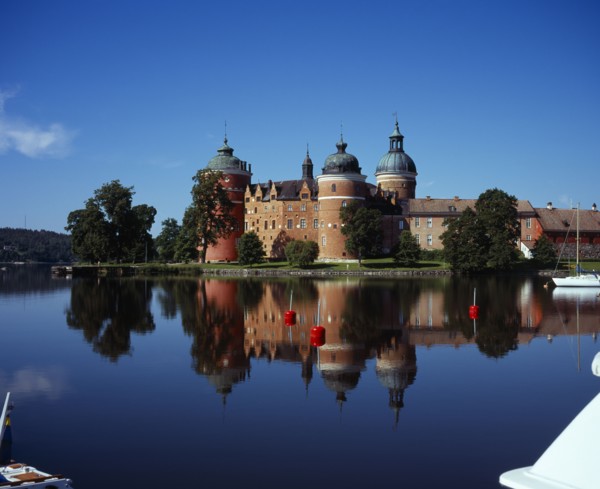 Sweden, Sodermanland, Mariefred, Gripsholm Castle beside Lake Malaren.  Red brick exterior with